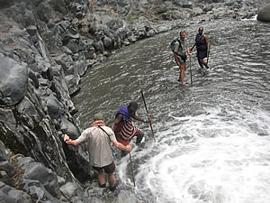 People exploring stream at Lake Natron